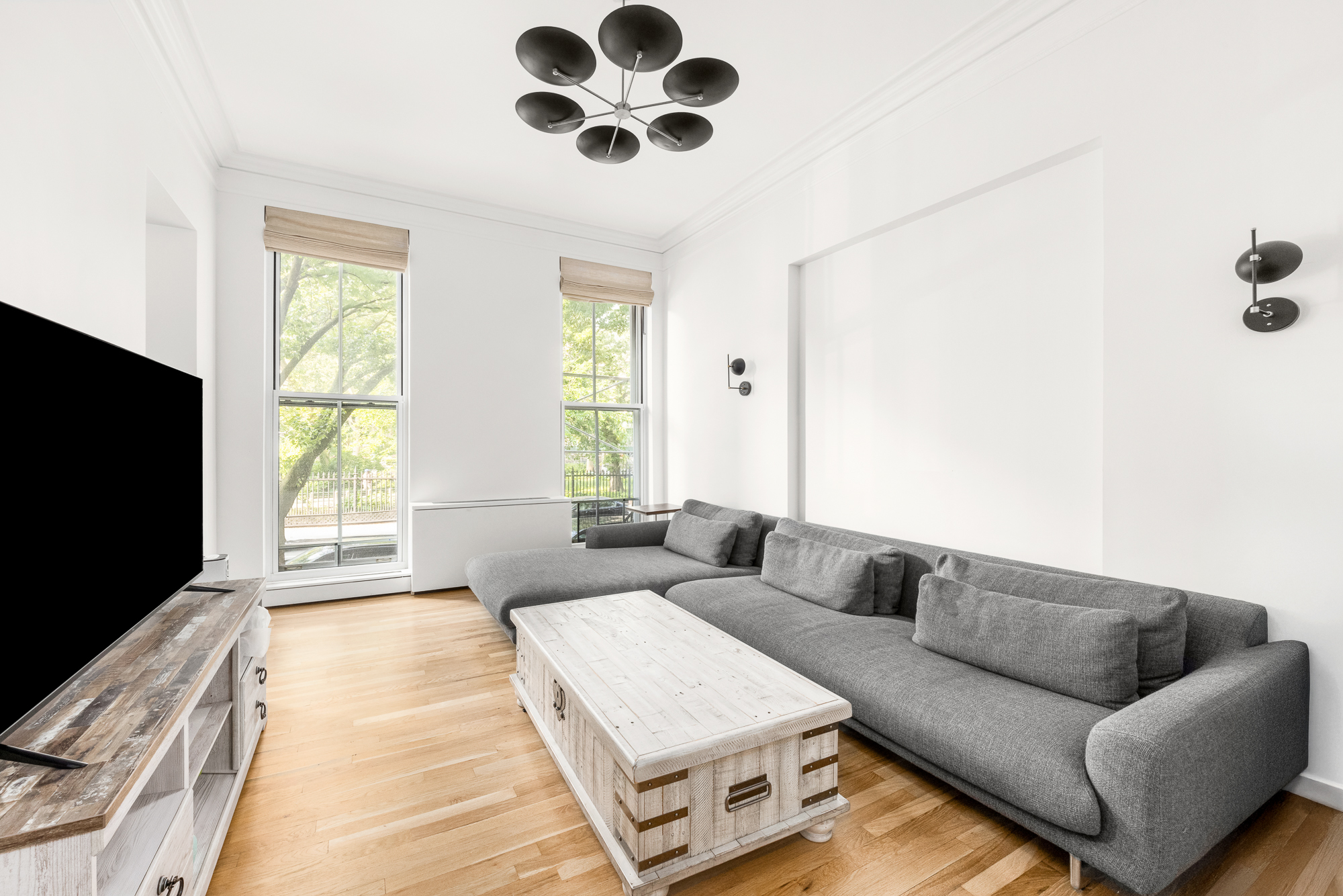 308 East 15th Street, Unit PARLOR Manhattan, NY 10003 - Photo 6 of 16 a living room with furniture and a flat screen tv