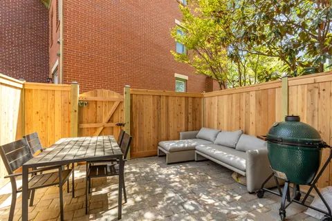 a backyard of a house with table and chairs