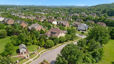 an aerial view of lake residential house with swimming pool and green space