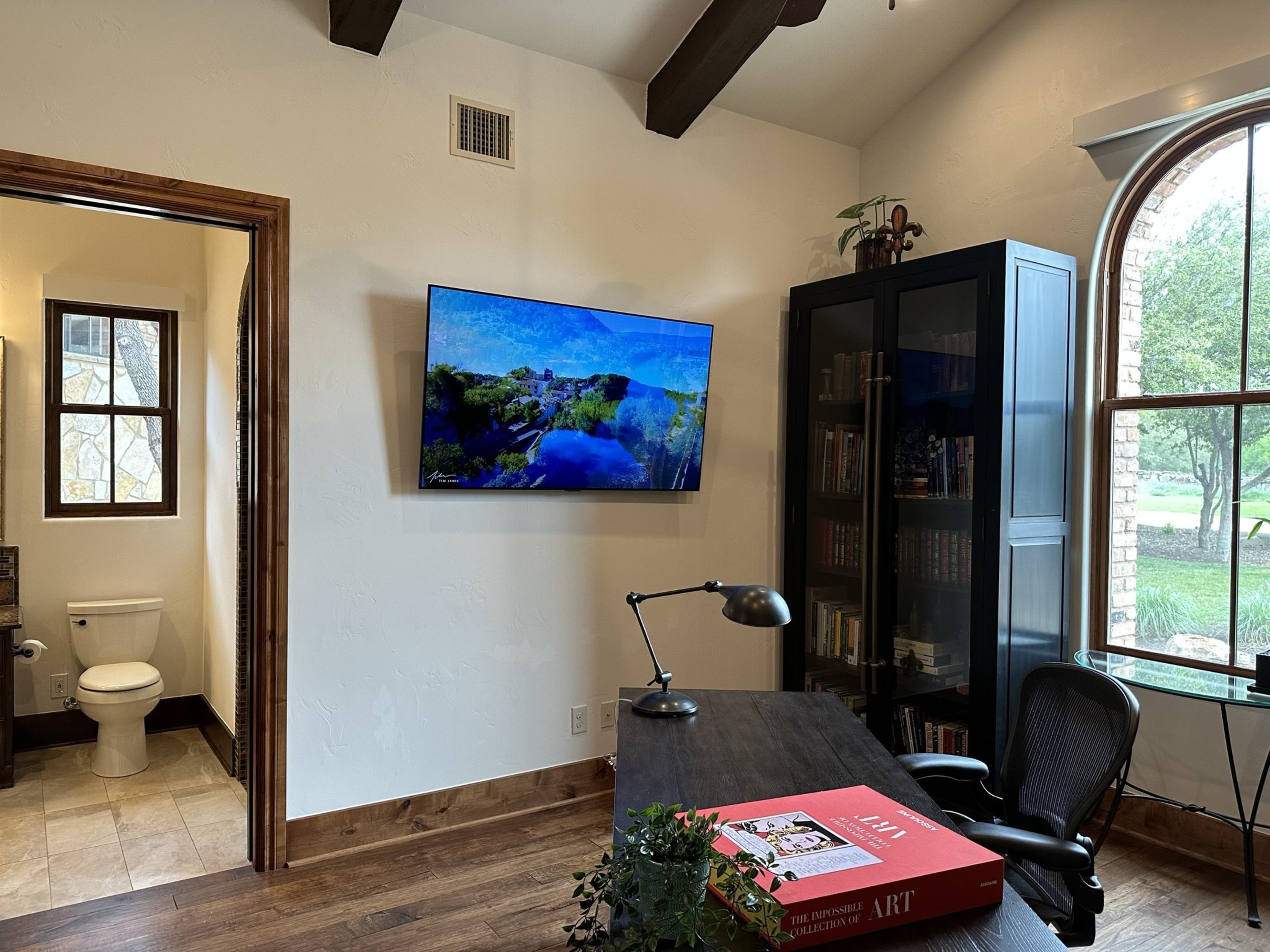 808 Rivercliff Drive Spicewood, TX 78669 - Photo 50 of 71 a bedroom with furniture and a window