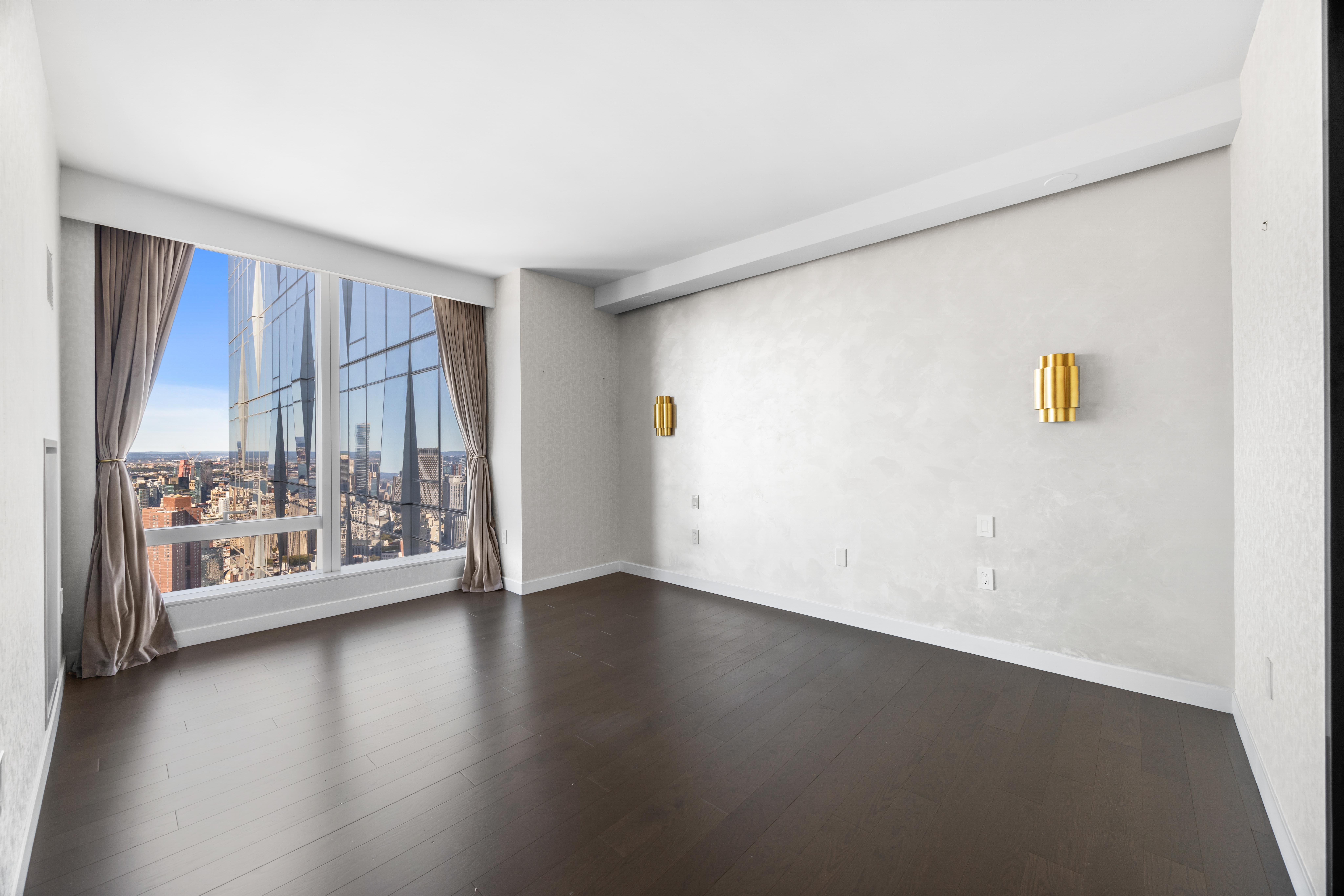 252 South Street, Unit 61A Manhattan, NY 10002 - Photo 5 of 29 an empty room with wooden floor and windows