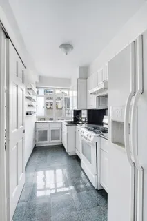 a kitchen with stainless steel appliances a refrigerator sink and cabinets