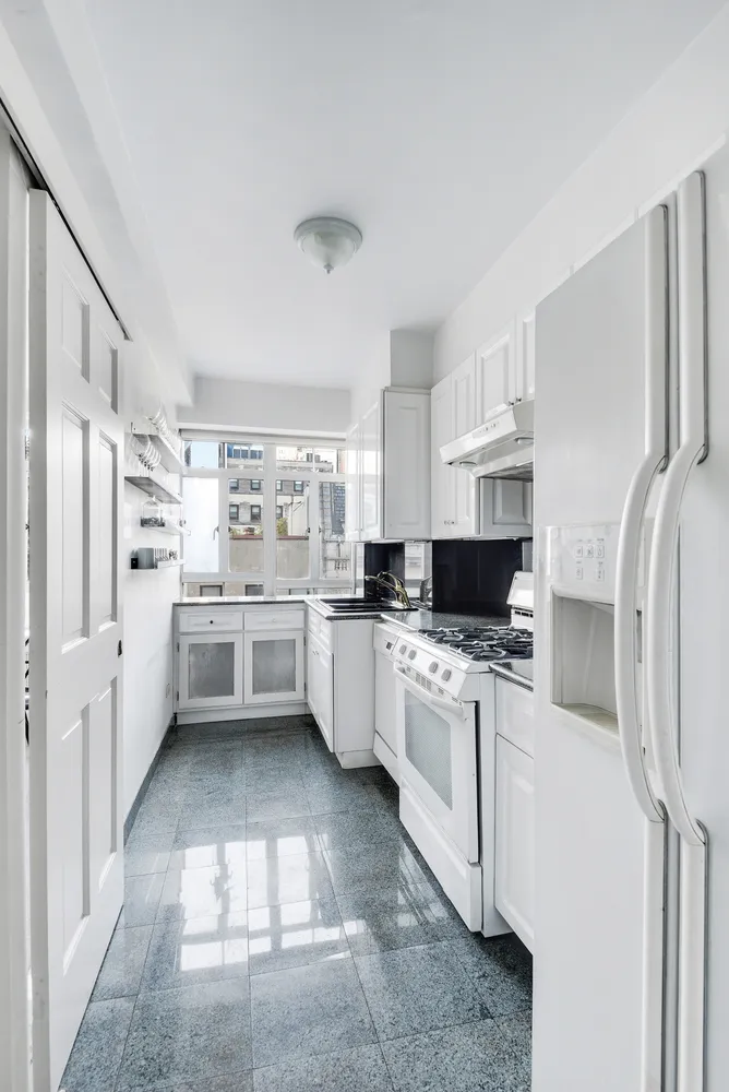 a kitchen with stainless steel appliances a refrigerator sink and cabinets