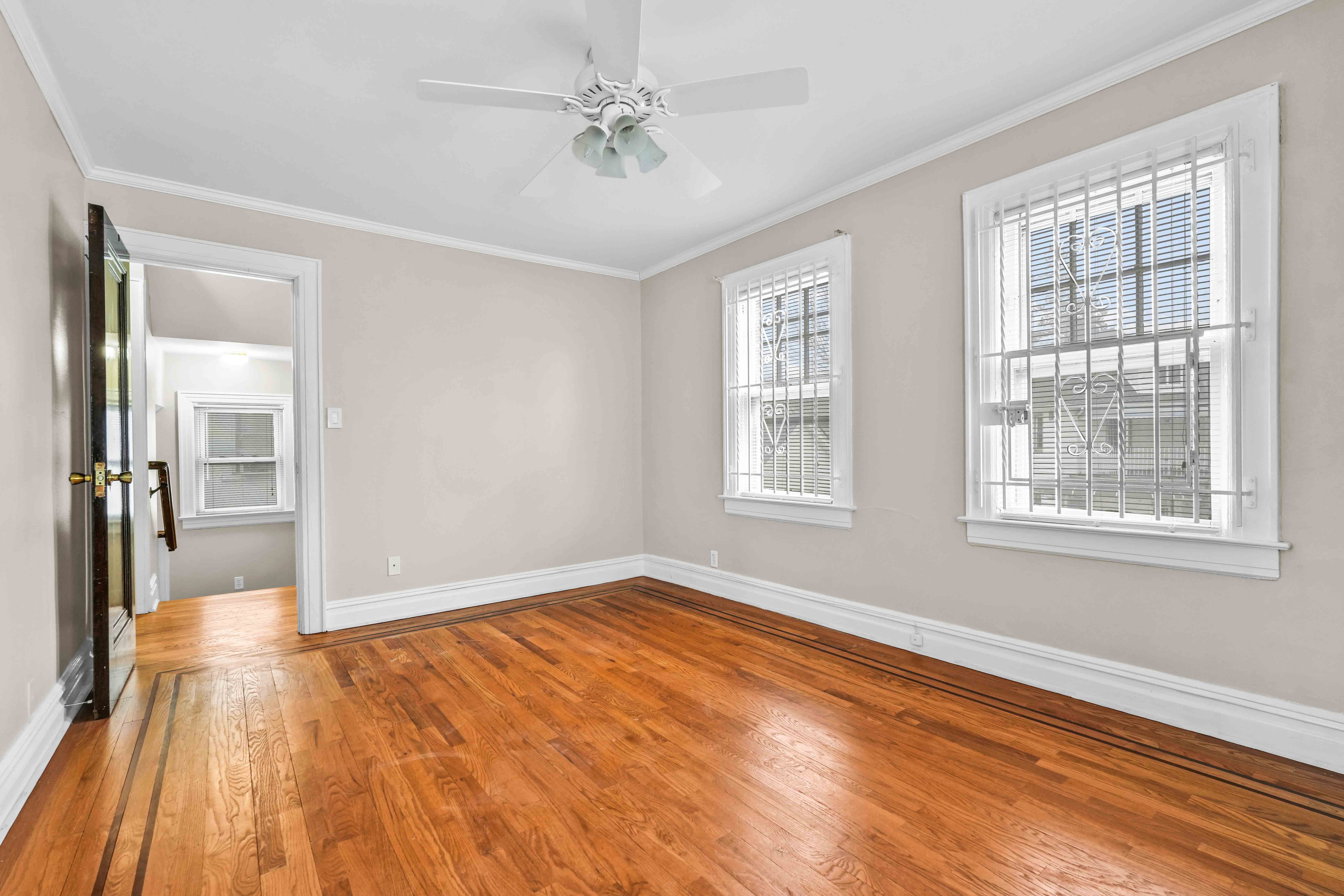 188-22 Lewiston Avenue, Unit 1 Queens, NY 11412 - Photo 12 of 17 a view of empty room with wooden floor and fan