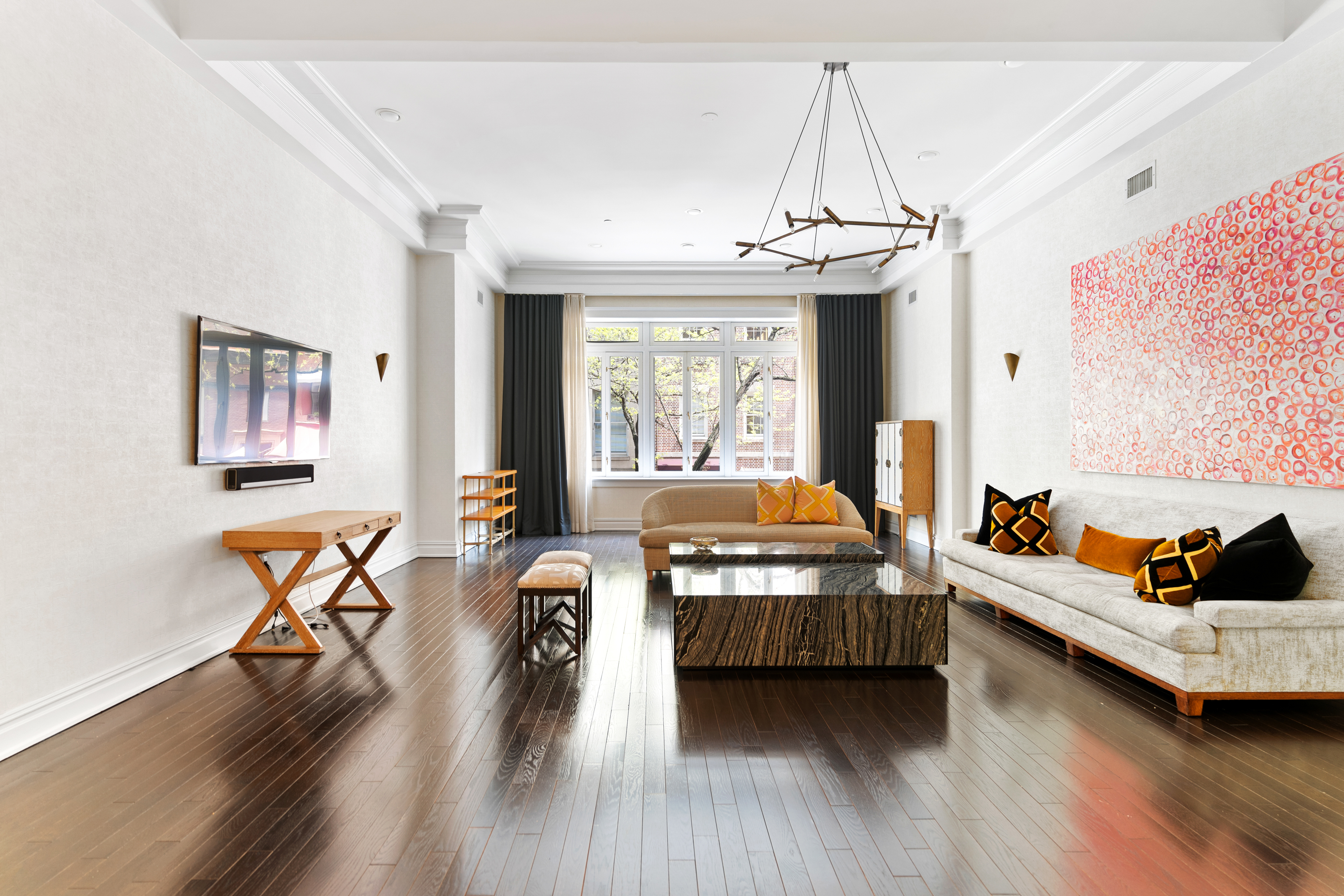 a living room with furniture and a chandelier