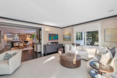 a kitchen with a dining table chairs and refrigerator