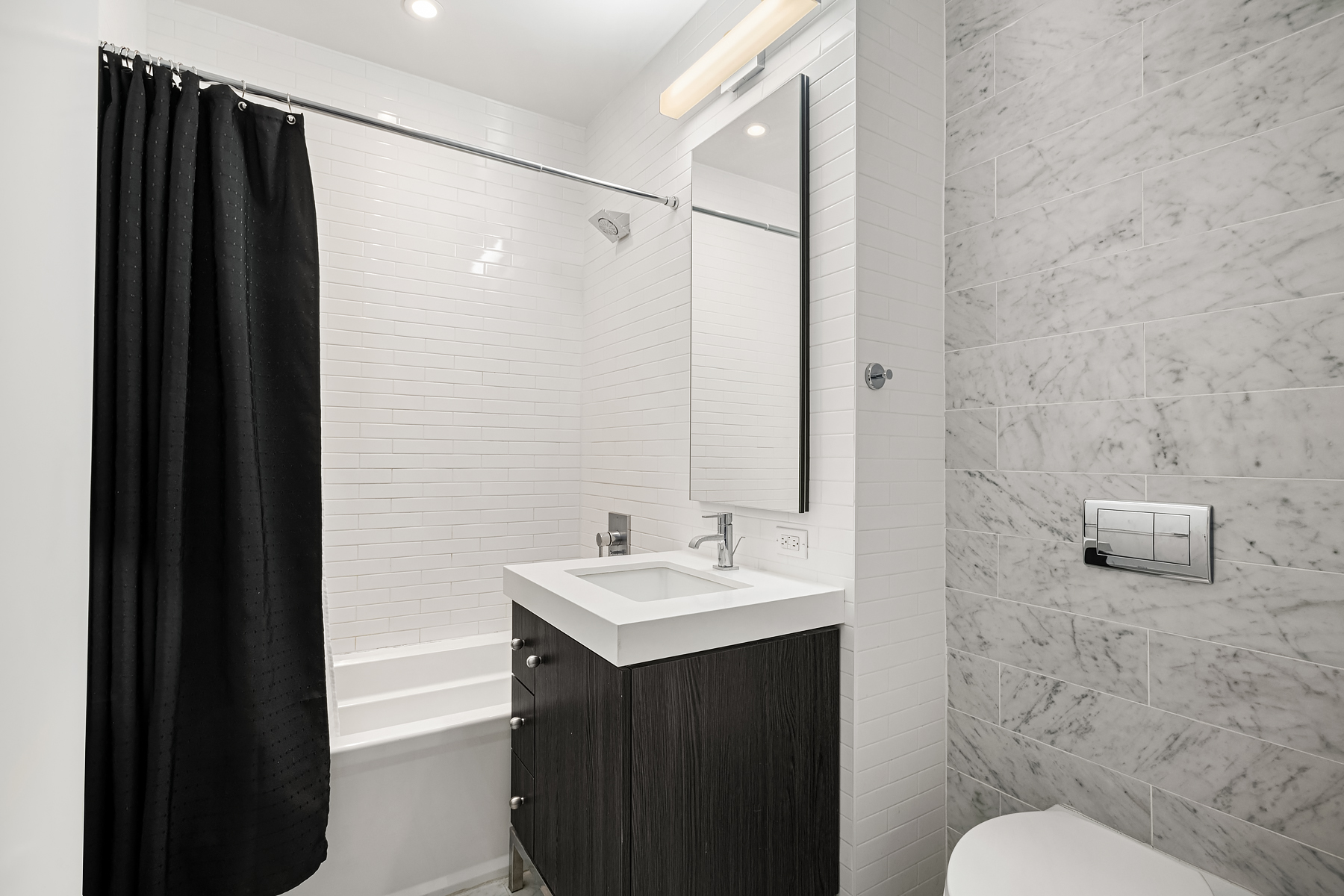 416 West 52nd Street, Unit 725 Manhattan, NY 10019 - Photo 4 of 15 a bathroom with a sink and a mirror