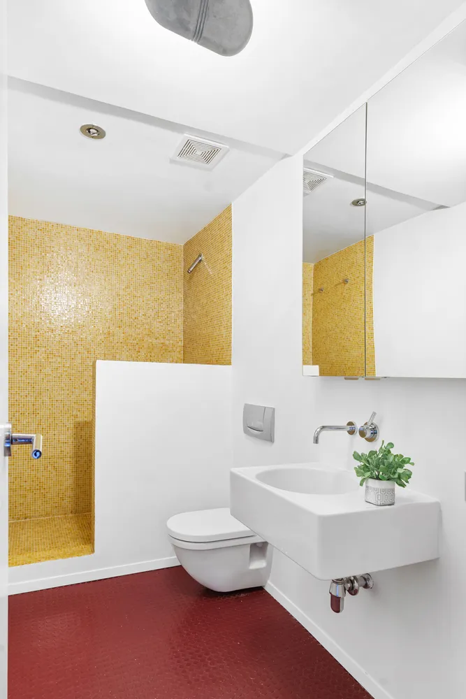 a bathroom with a sink a toilet and mirror