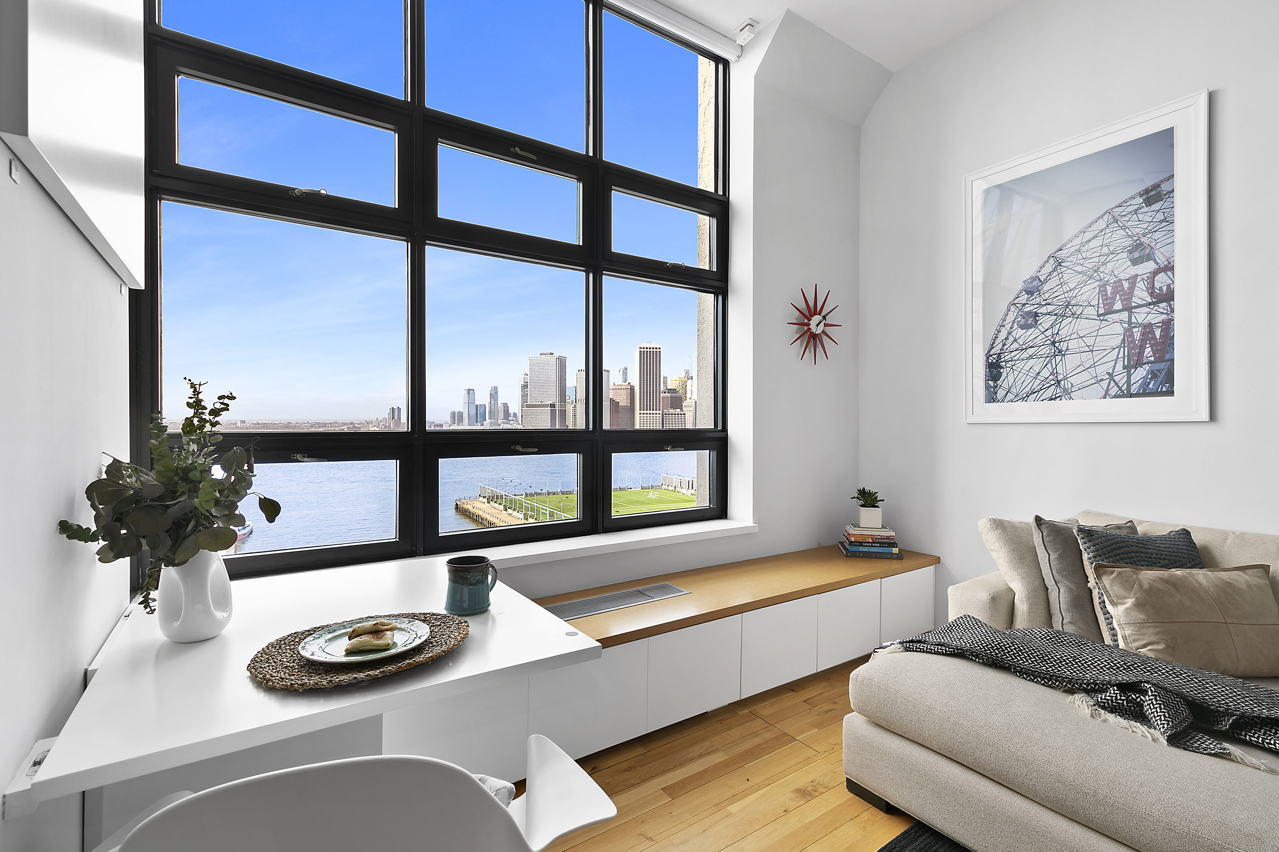 a living room with furniture and a potted plant
