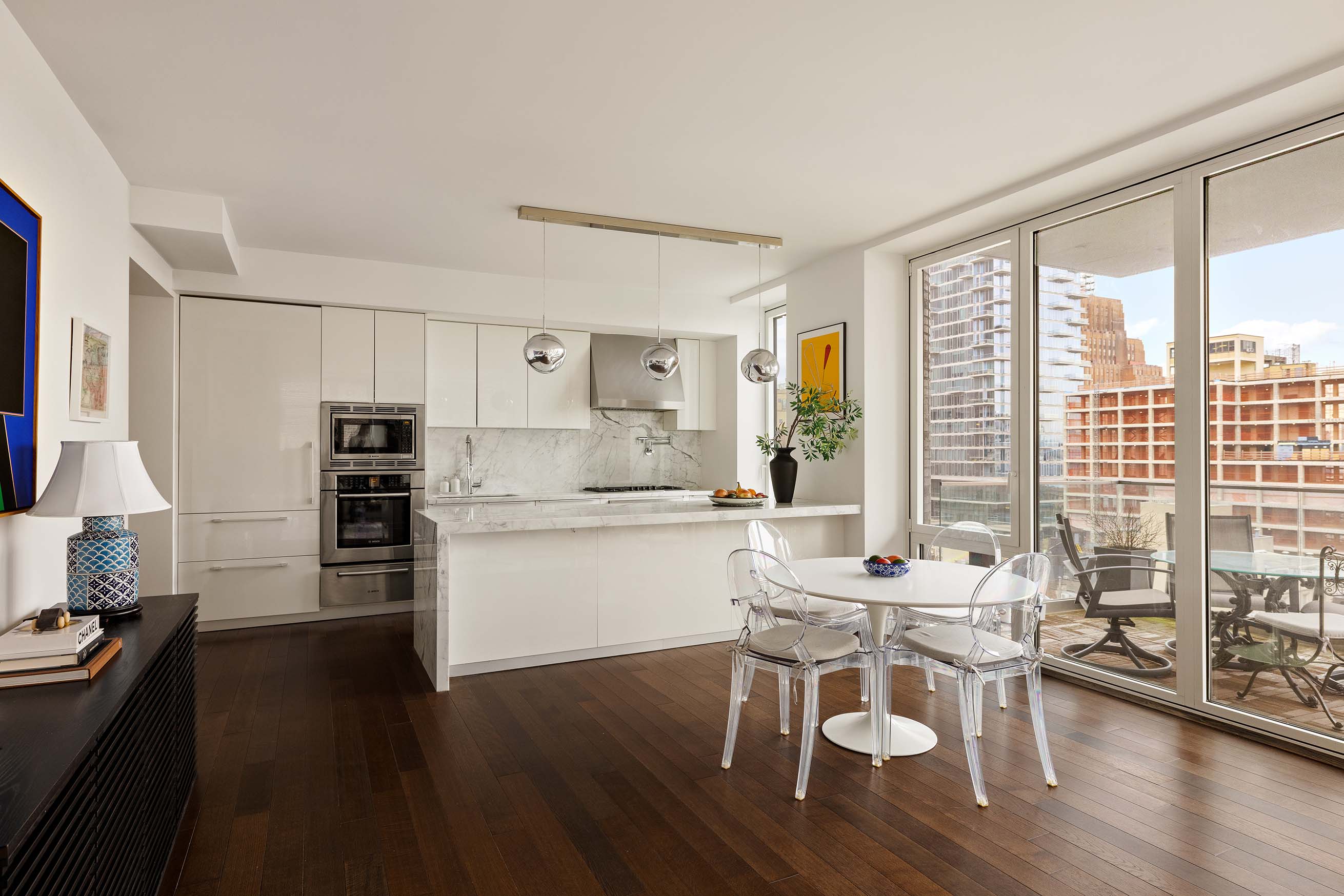 5 Franklin Place, Unit 14A Manhattan, NY 10013 - Photo 4 of 23 a kitchen with a dining table chairs and refrigerator