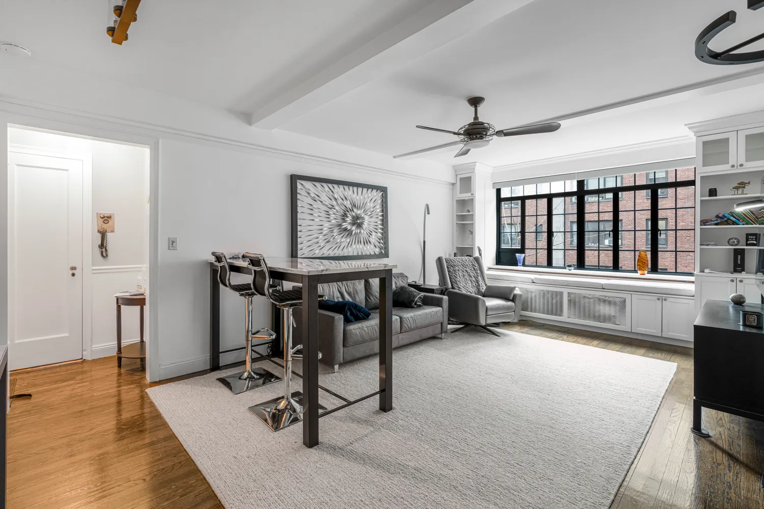 a view of a livingroom with furniture and a ceiling fan