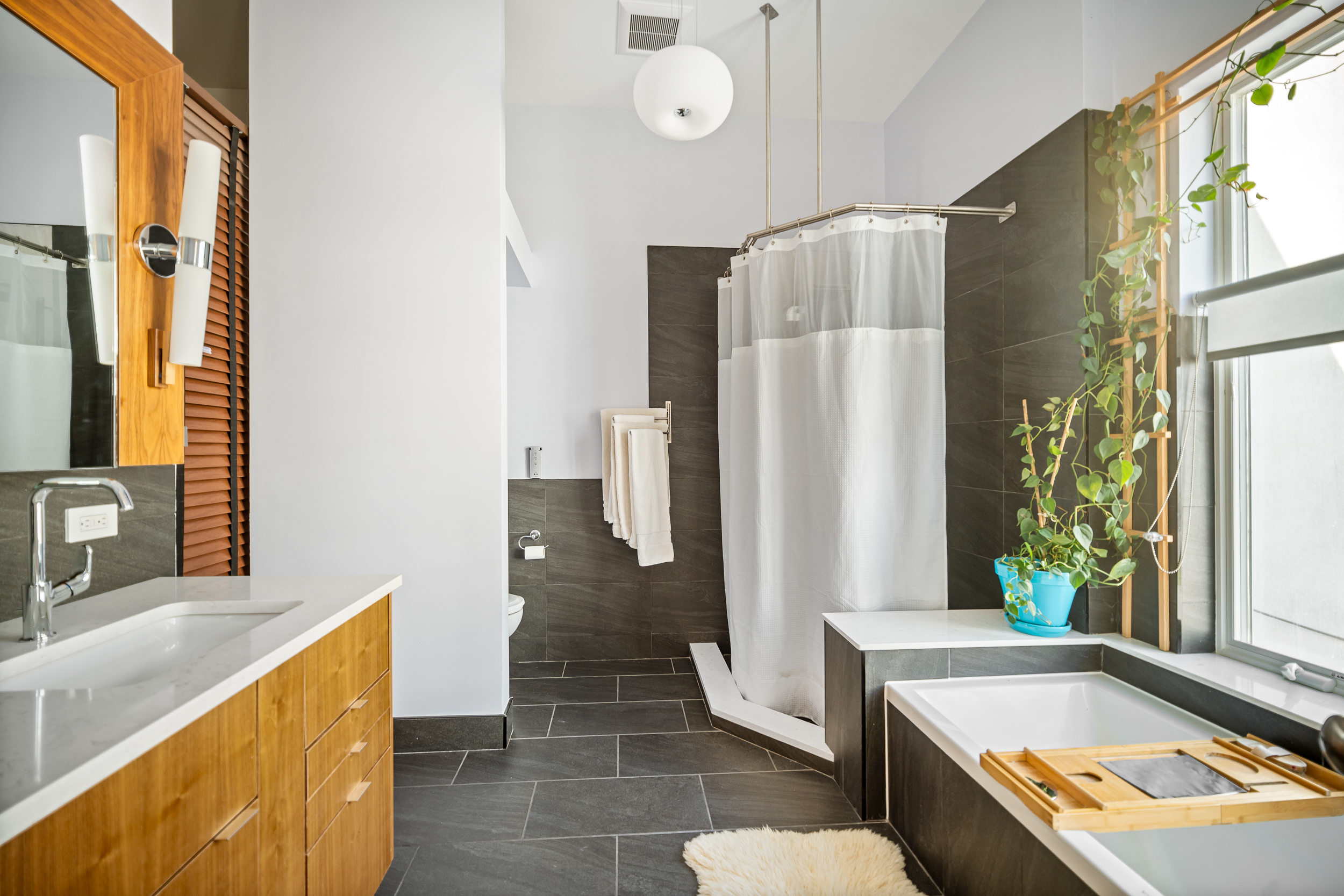 65 Jackson Street Brooklyn, NY 11211 - Photo 15 of 36 a bathroom with a tub a sink and a large window