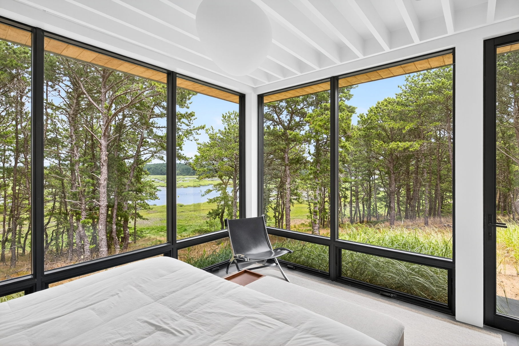 375 King Phillip Road Wellfleet, MA 02667 - Photo 25 of 27 a bedroom with furniture and large windows