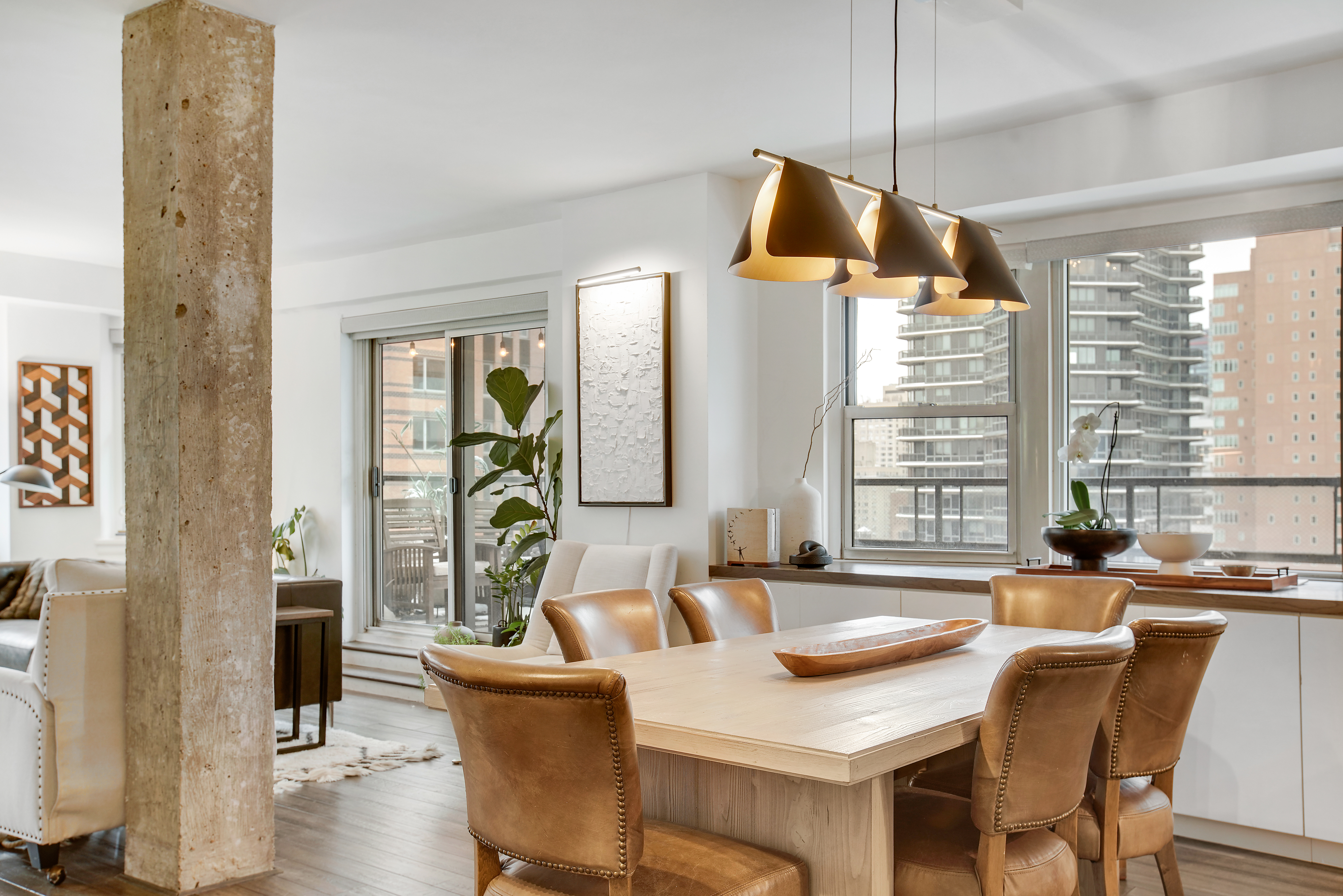 175 East 62nd Street, Unit 18B Manhattan, NY 10065 - Photo 5 of 18 a view of a dining room and livingroom with furniture wooden floor a chandelier