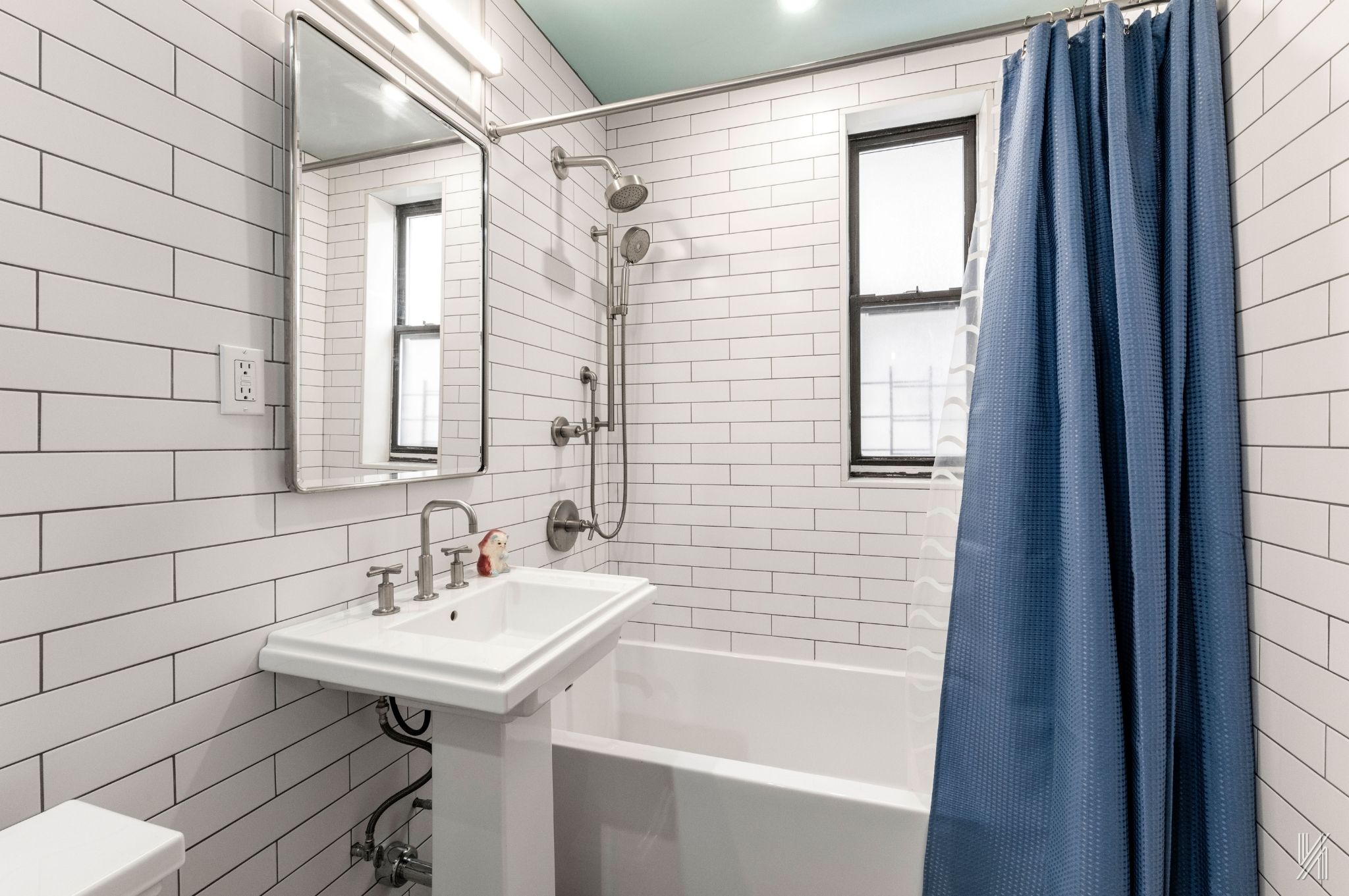 35-06 88th Street, Unit 3G Queens, NY 11372 - Photo 16 of 20 a bathroom with a sink a mirror and a shower