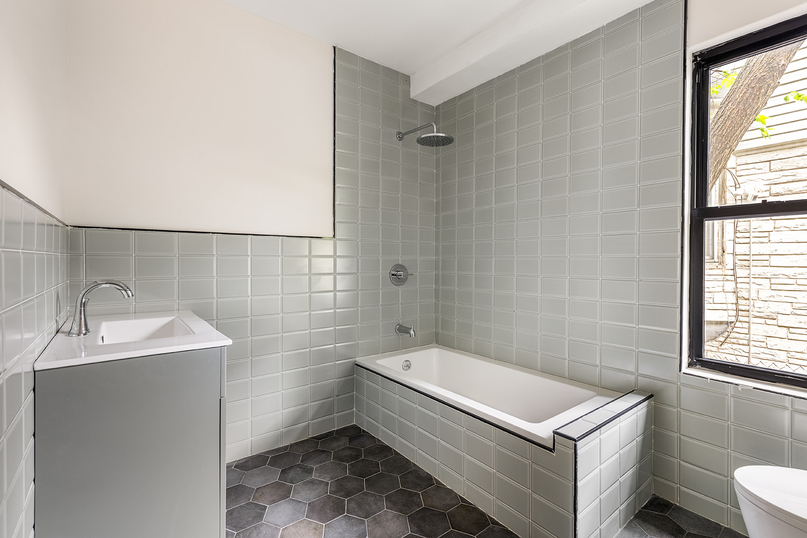 697 East 21st Street Brooklyn, NY 11210 - Photo 15 of 18 a bathroom with a sink toilet and shower