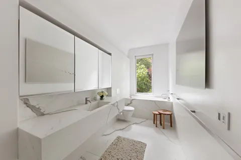 a spacious bathroom with a bathtub a sink and a window