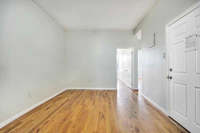 255 Covert Street Brooklyn, NY 11207 - Photo 2 of 18 a view of a room with wooden floor and a bathroom