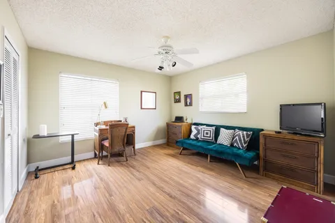 a living room with furniture and a wooden floor