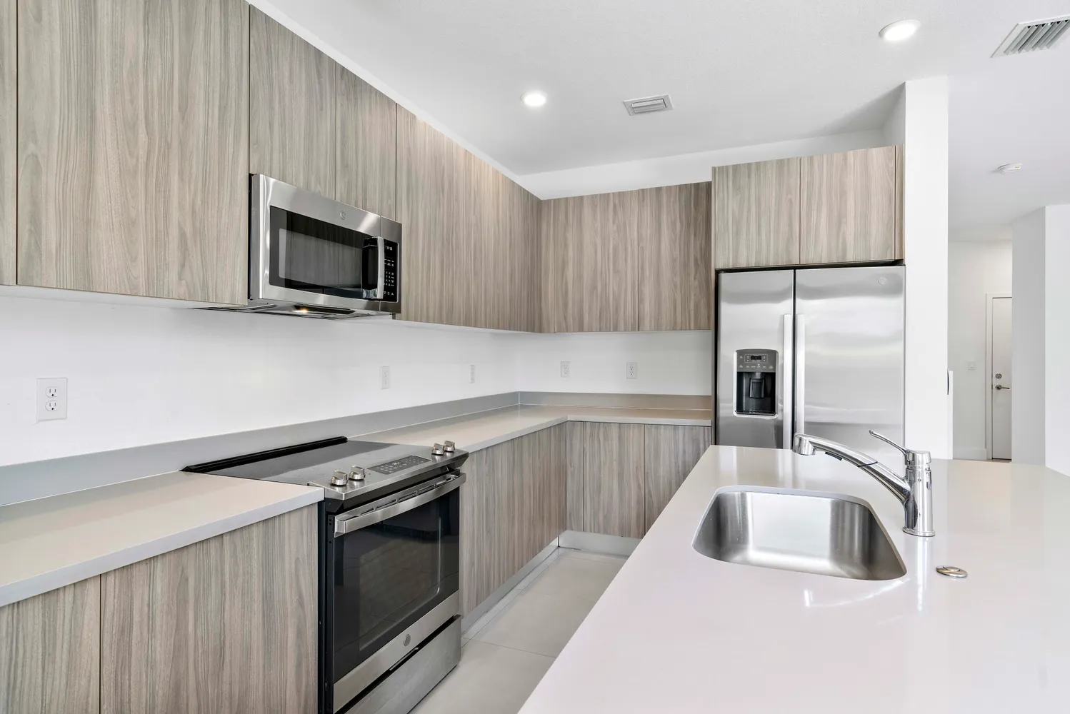 a kitchen with a sink stove and microwave