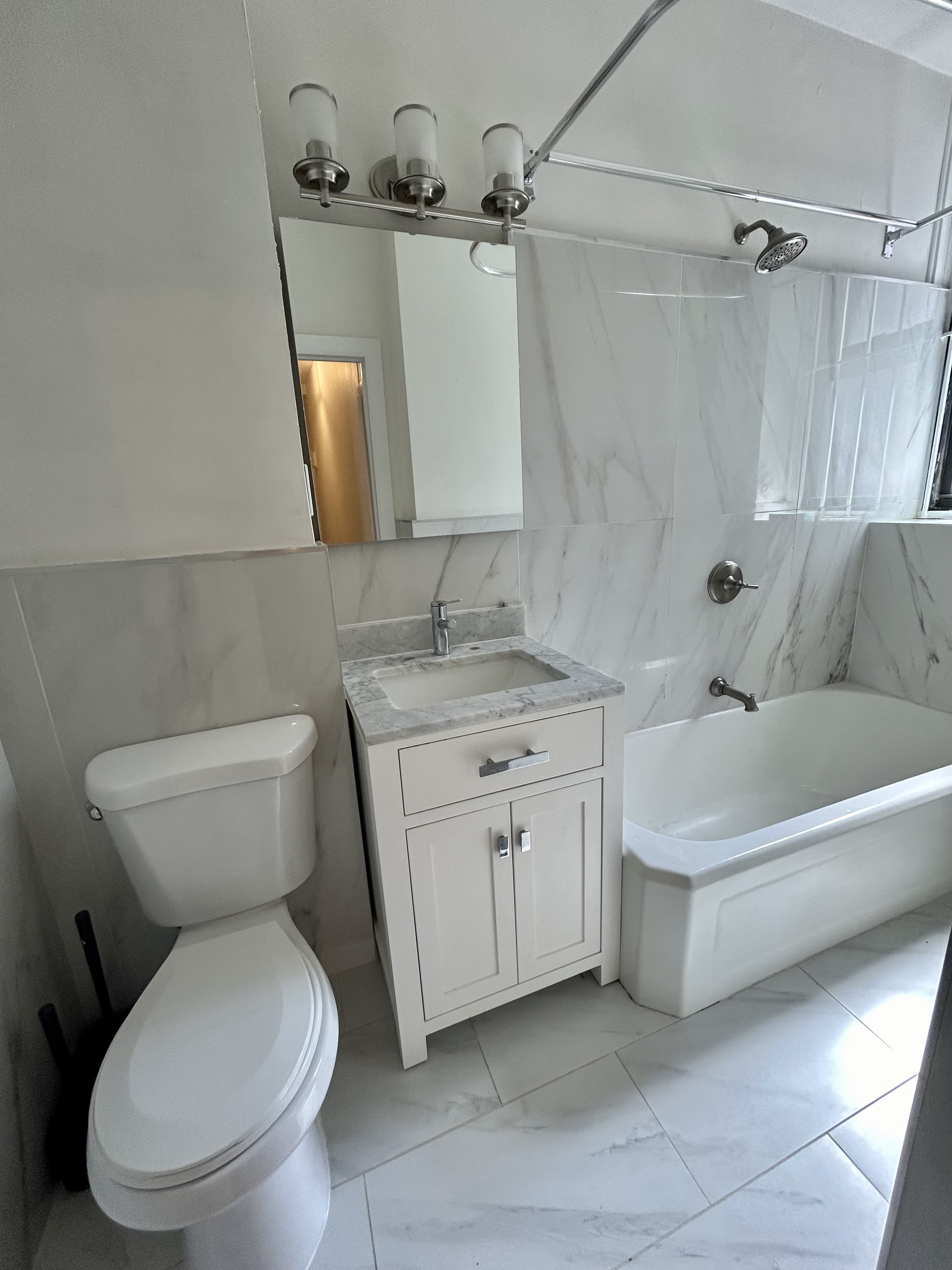 504 West 110th Street, Unit 3B Manhattan, NY 10025 - Photo 5 of 6 a bathroom with a toilet sink and mirror