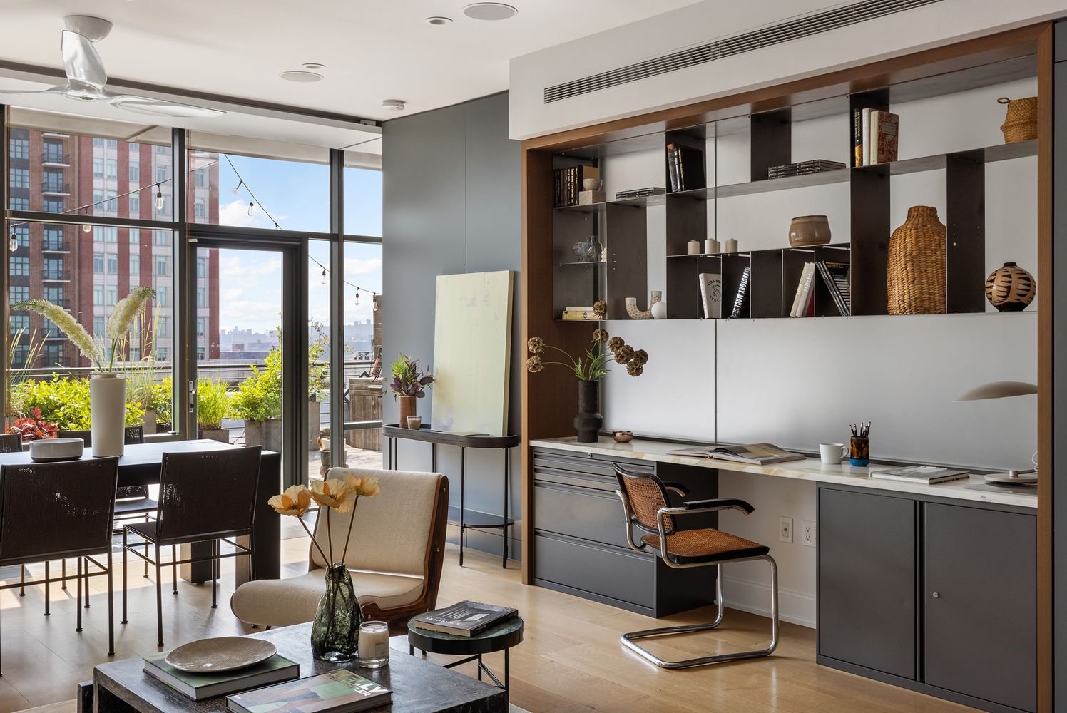 a work room with furniture and large windows