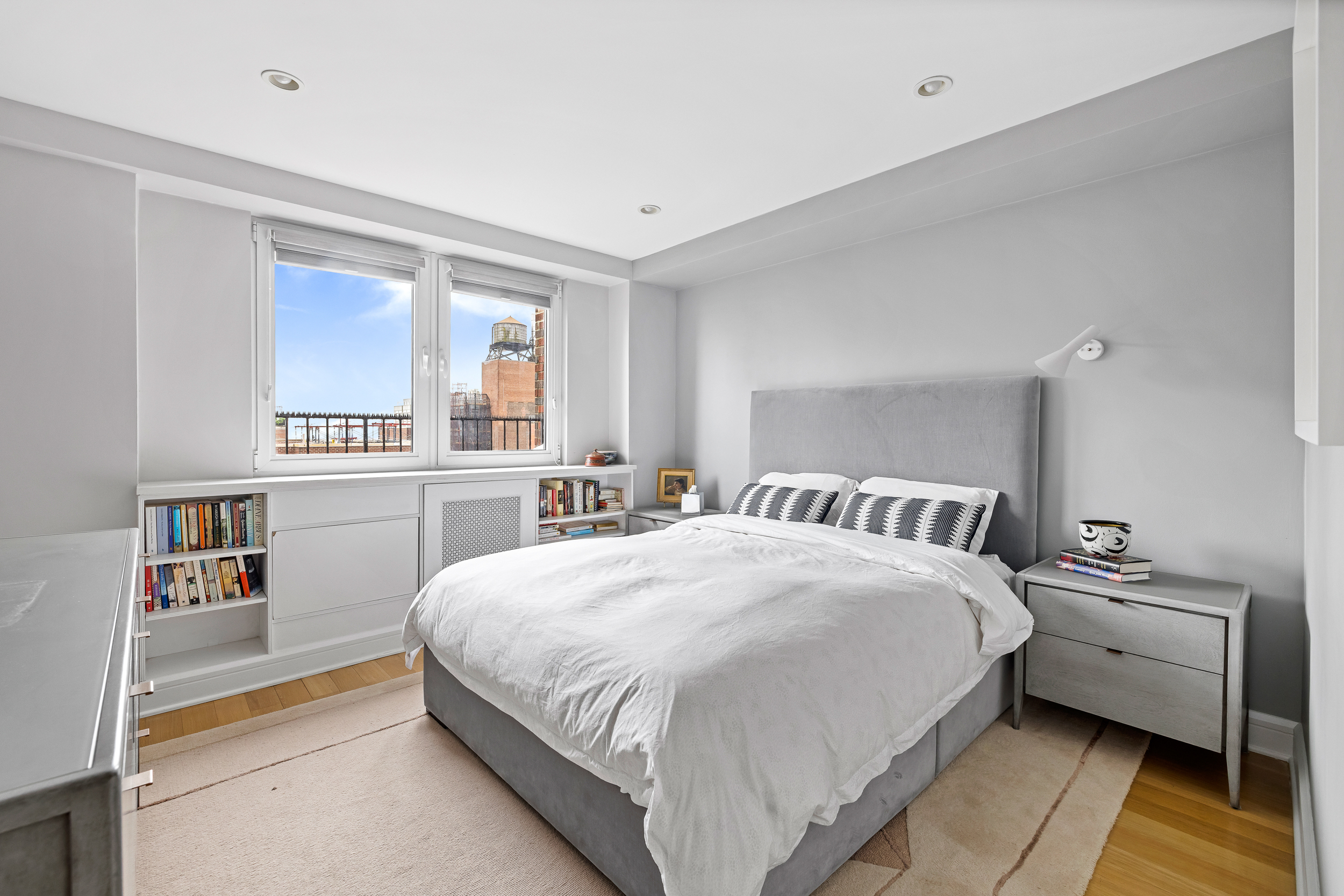 80 East End Avenue, Unit 17C Manhattan, NY 10028 - Photo 9 of 11 a bedroom with a bed and a large window