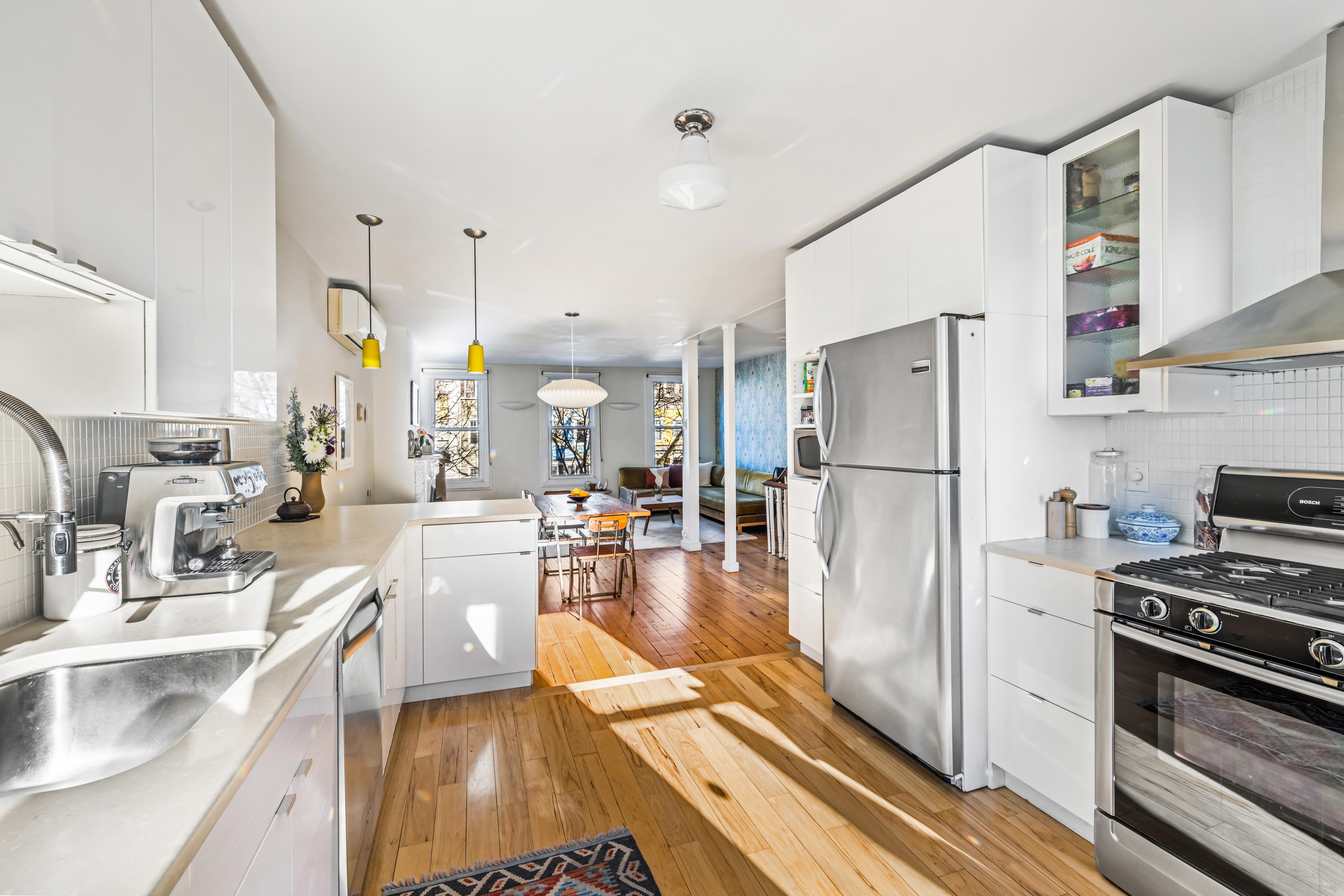 226 11th Street, Unit 2 Brooklyn, NY 11215 - Photo 5 of 19 a kitchen with a refrigerator a stove and a sink with wooden floor