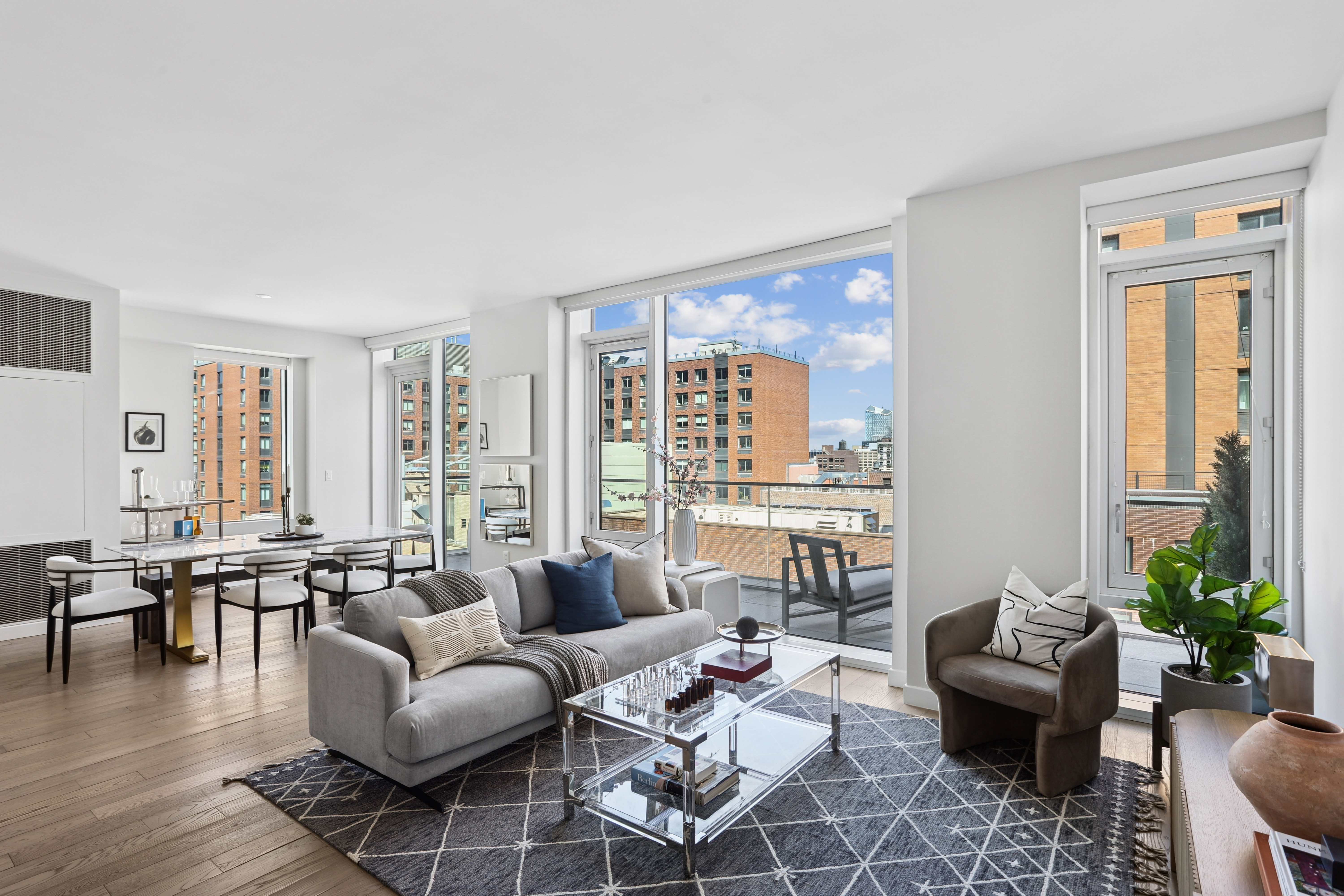 a living room with furniture and floor to ceiling windows