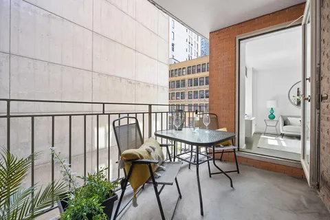 a view of a room with furniture and wooden floor