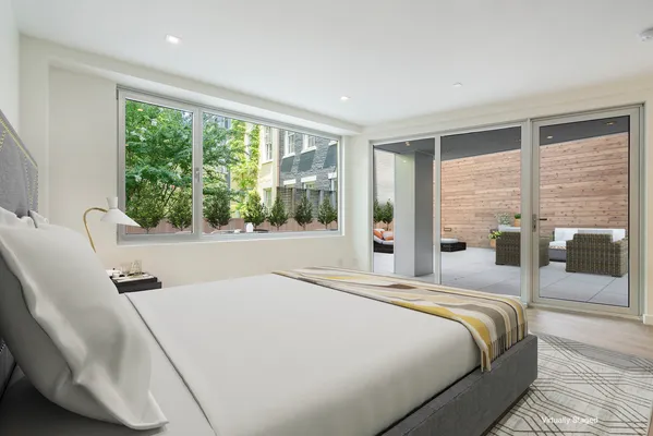 a bedroom with a large bed and a large window