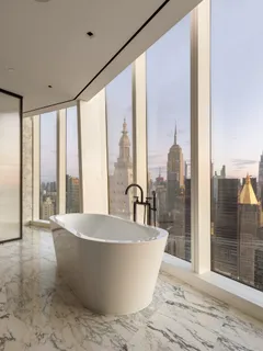a large tub sitting next to a large window