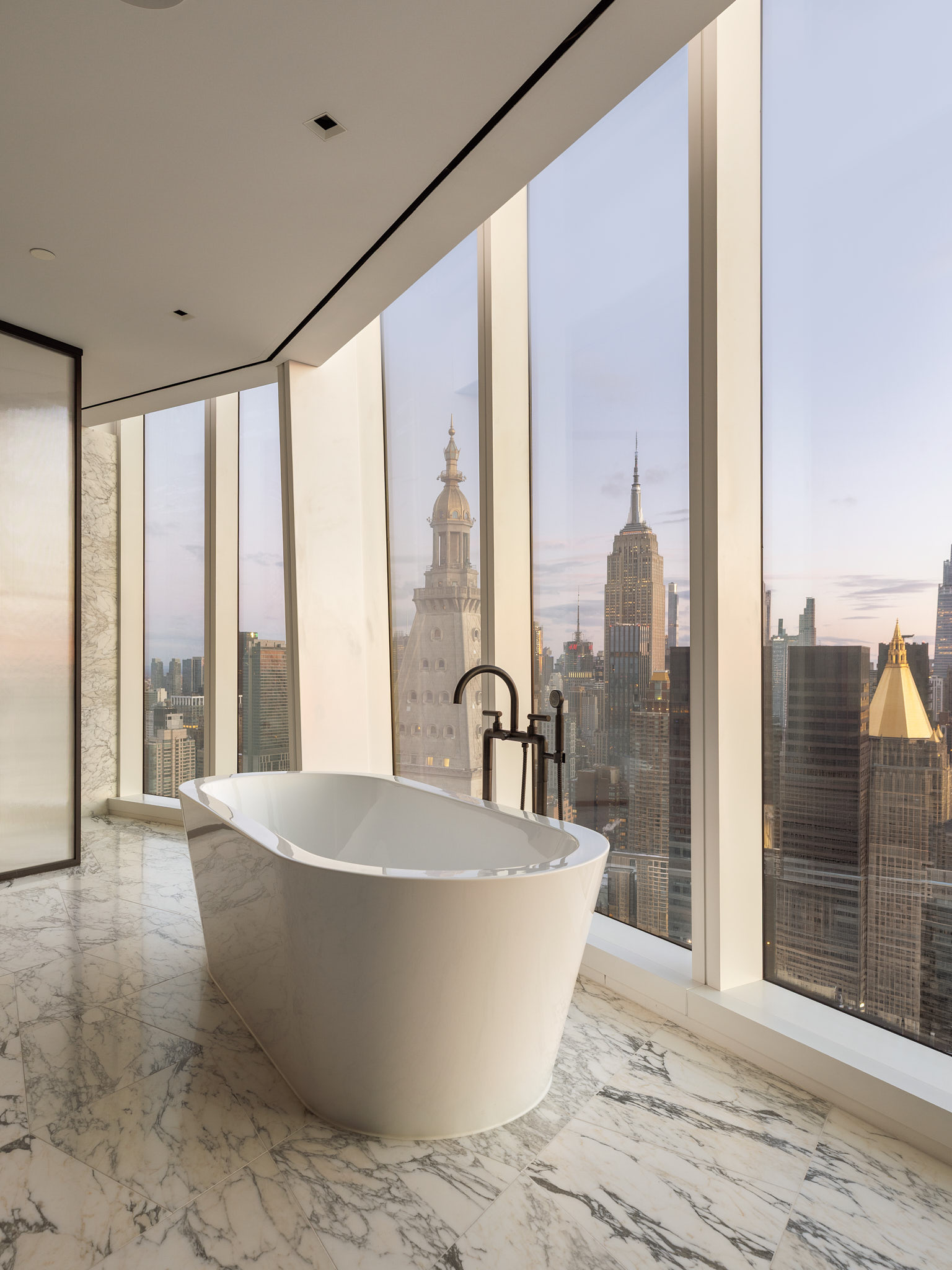 45 East 22nd Street, Unit 52/53B Manhattan, NY 10010 - Photo 12 of 27 a large tub sitting next to a large window