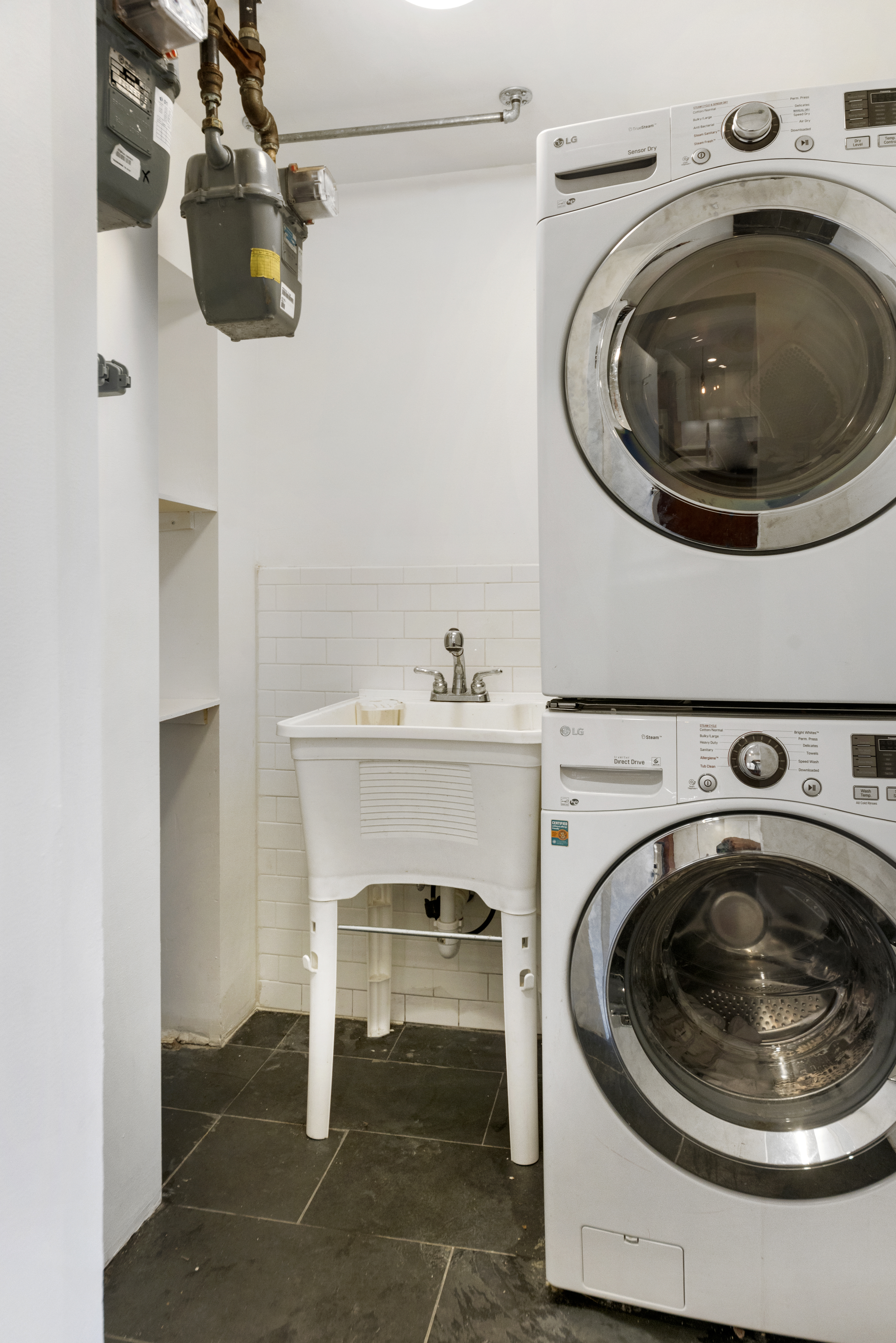 57 Hendrix Street, Unit 1 Brooklyn, NY 11207 - Photo 9 of 12 a utility room with sink dryer and washer