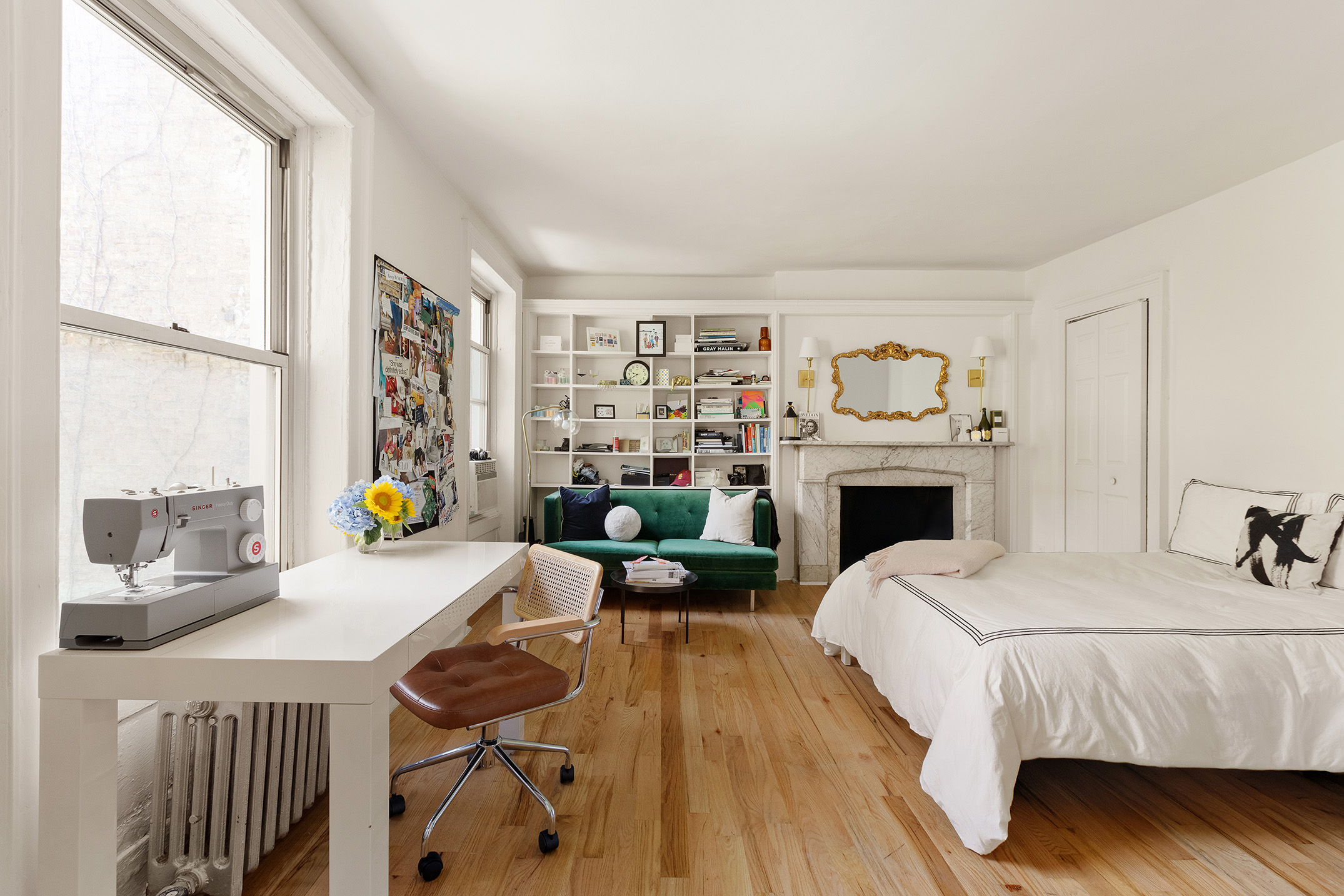 311 East 9th Street, Unit 2R Manhattan, NY 10003 - Photo 4 of 5 a living room with furniture a fireplace and a large window