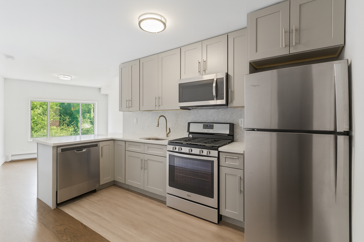 187 Woodpoint Road Brooklyn, NY 11211 - Photo 2 of 17 a kitchen with cabinets stainless steel appliances and wooden floor