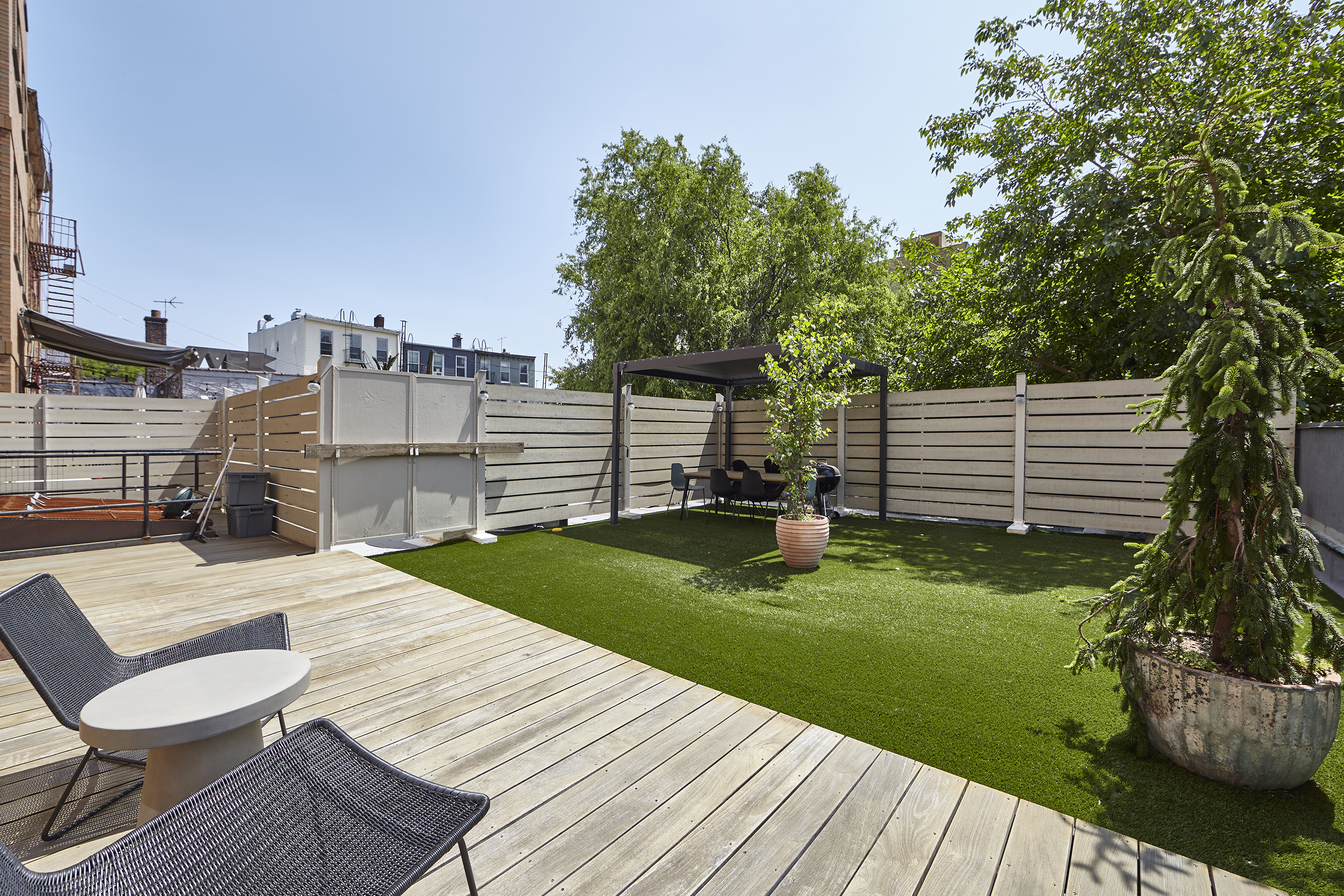 144 North 10th Street, Unit 2D Brooklyn, NY 11249 - Photo 10 of 12 a view of a chairs and table on the wooden deck