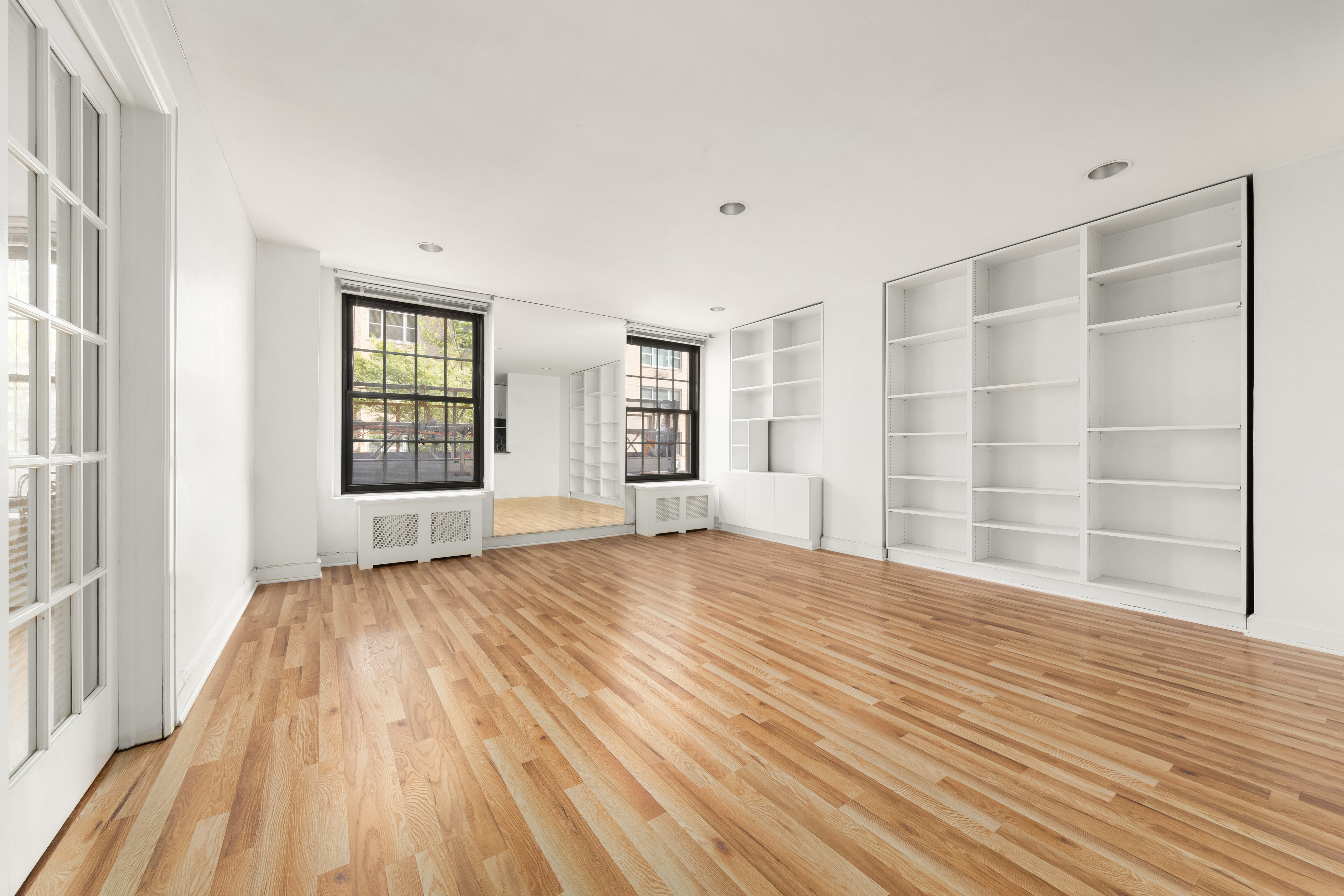 1 5th Avenue, Unit 2B Manhattan, NY 10003 - Photo 3 of 12 a view of an empty room with wooden floor and a window