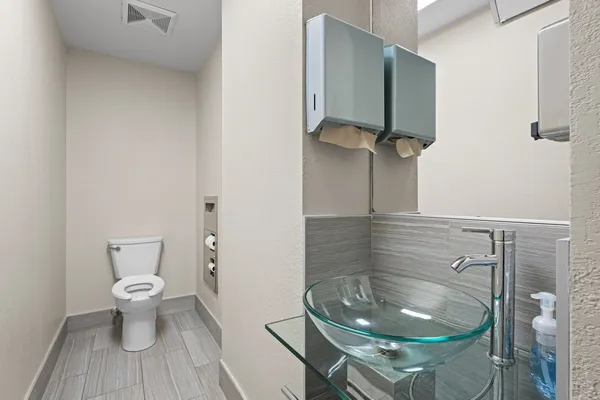 a bathroom with a toilet and a mirror
