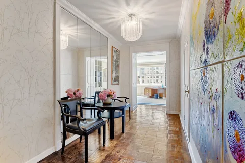a view of a dining room with furniture and chandelier