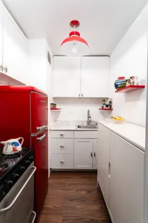 a kitchen with a sink cabinets and white appliances