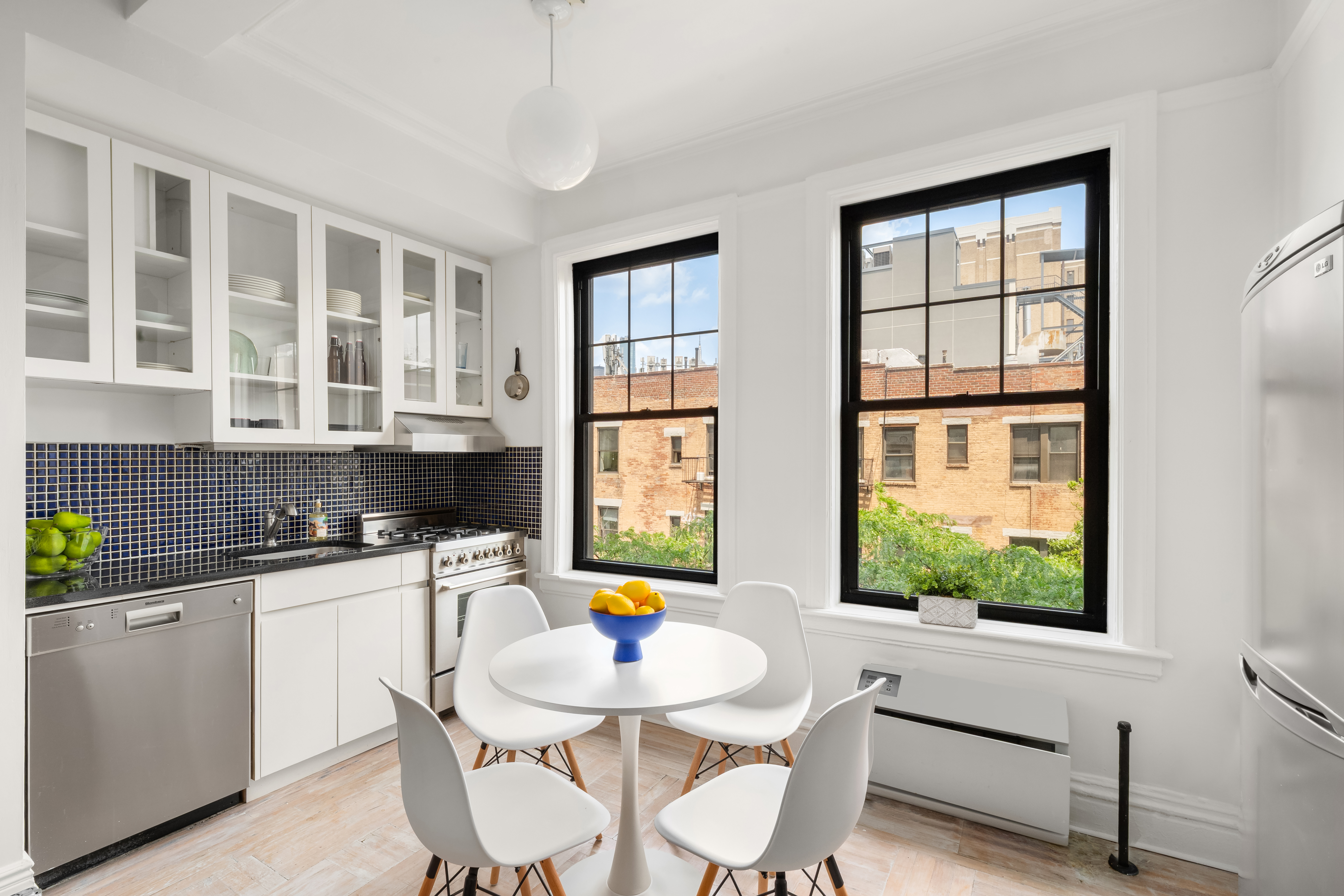 170 2nd Avenue, Unit 5C Manhattan, NY 10003 - Photo 2 of 8 a dining room with a window and chairs