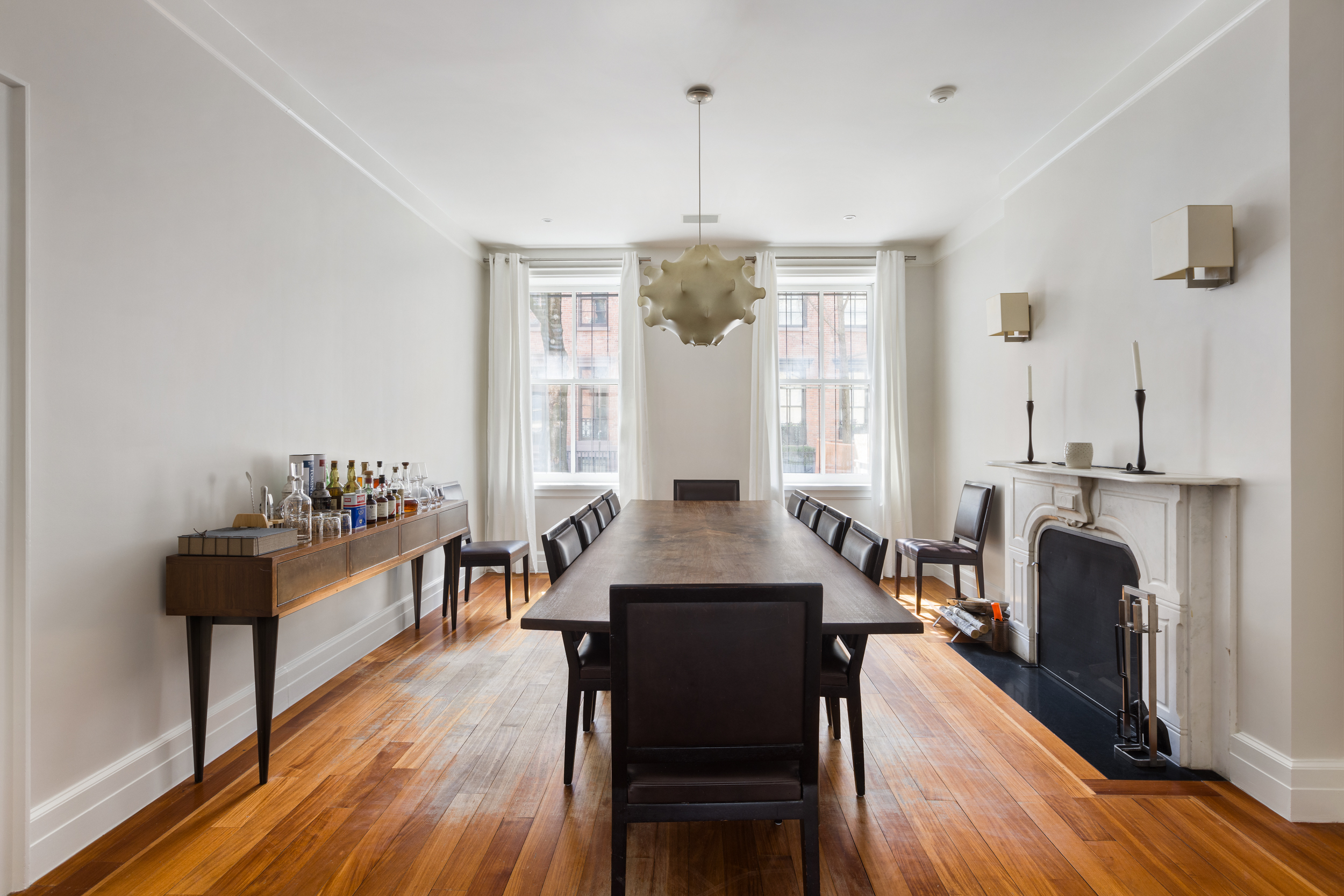 83 Jane Street, Unit TH1 Manhattan, NY 10014 - Photo 8 of 29 a dining room with furniture a chandelier and wooden floor