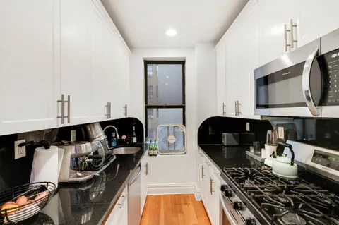 a kitchen with a stove and a microwave