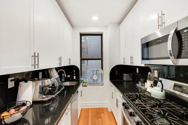 a kitchen with a stove and a microwave