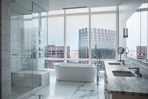 a living room with large windows and a table