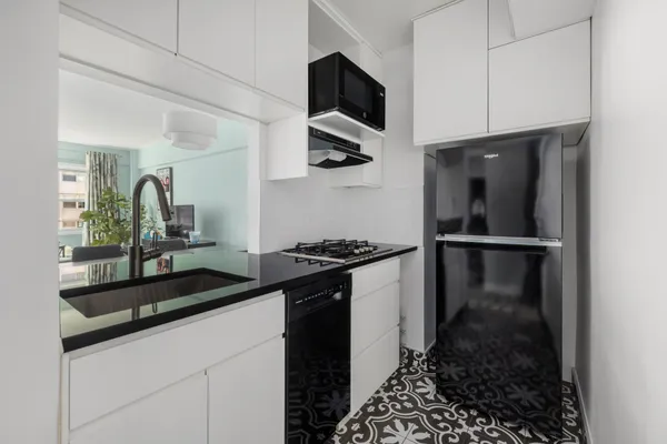 a kitchen with a sink and stainless steel appliances