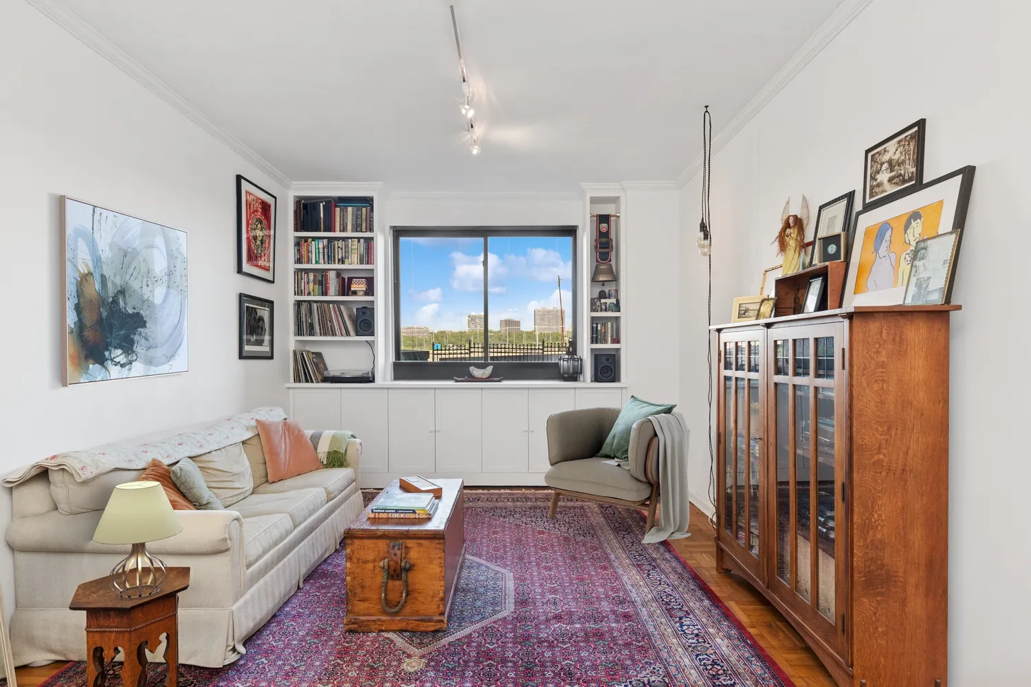 a living room with furniture and a book shelf
