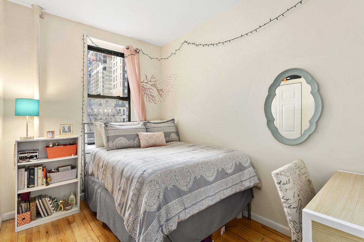 309 East 95th Street, Unit 27 Manhattan, NY 10128 - Photo 7 of 8 a bedroom with a bed a dresser and a large window