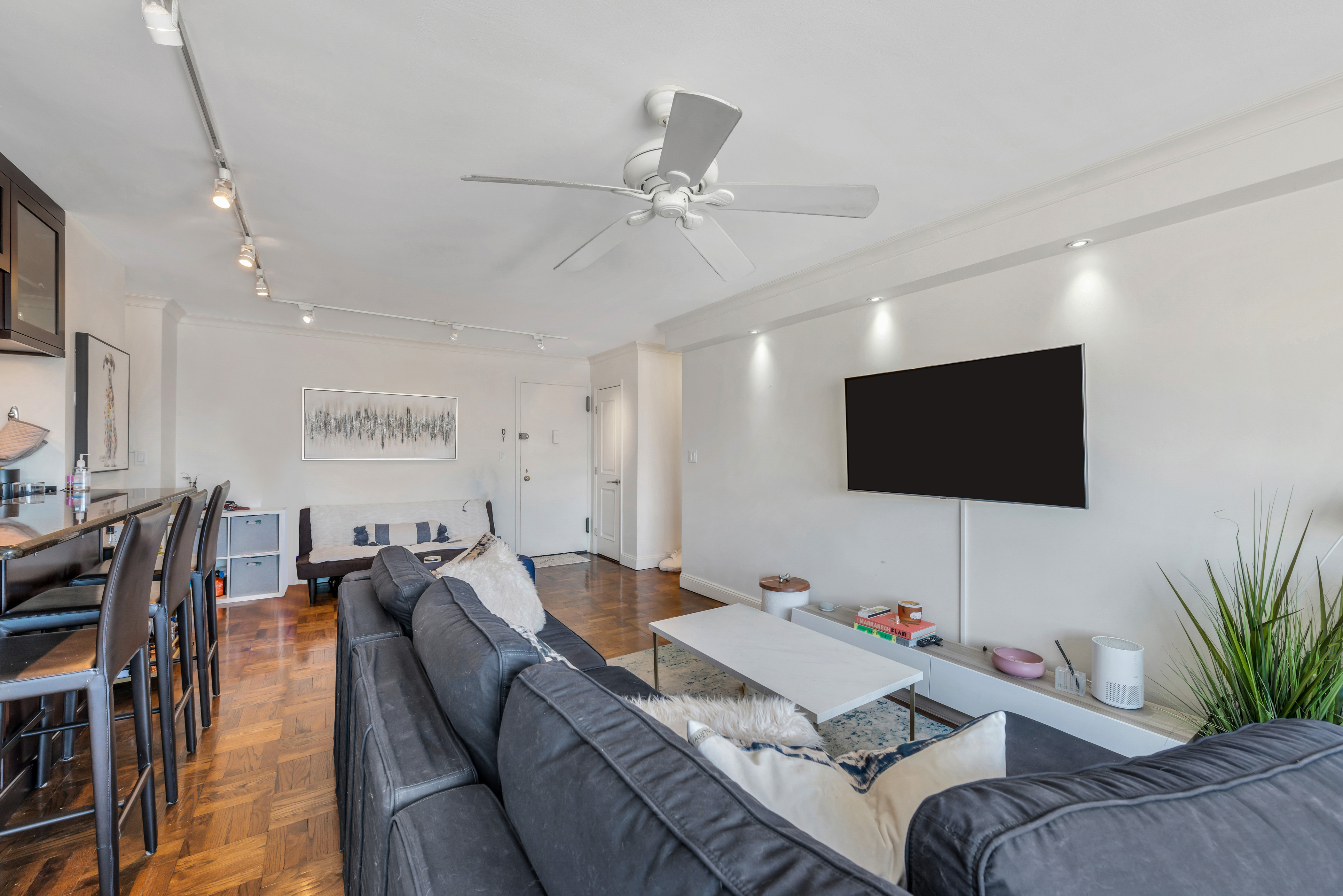 175 West 12th Street, Unit 12F Manhattan, NY 10011 - Photo 3 of 10 a living room with furniture and a flat screen tv
